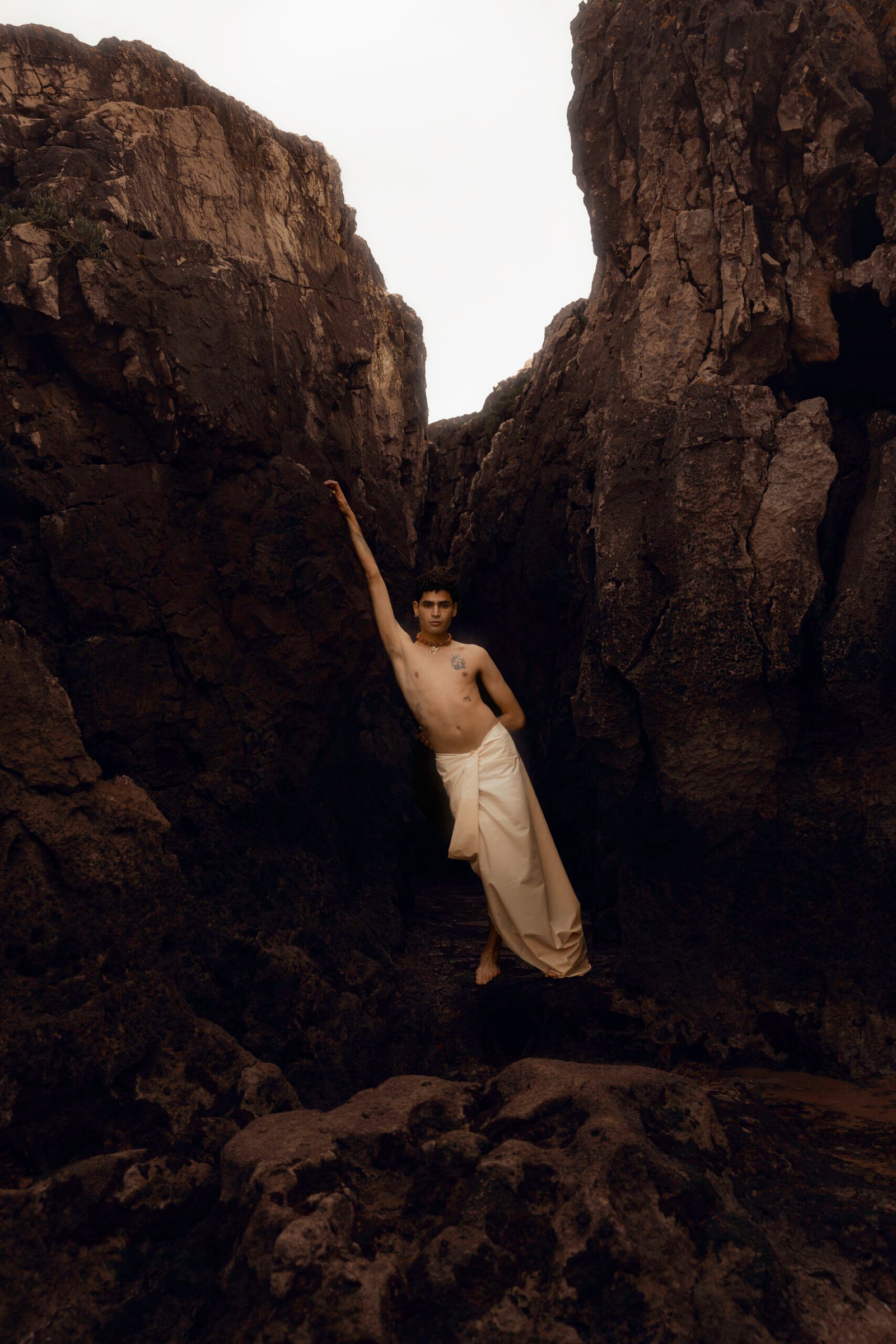 Portrait de Yanis posant entre les rochers lors d’un voyage photo au Portugal